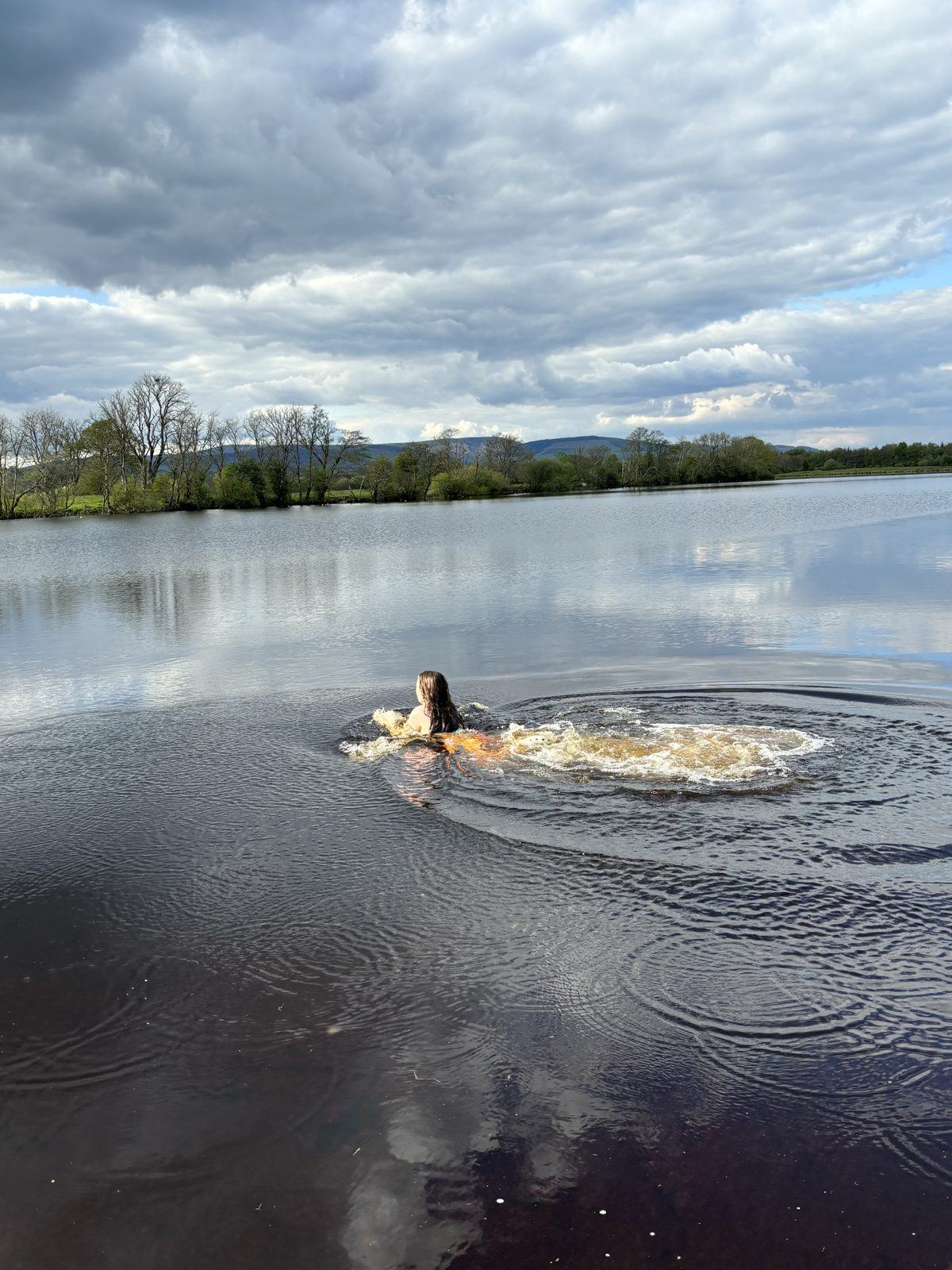 A swimmer heading out into the still River Shannon